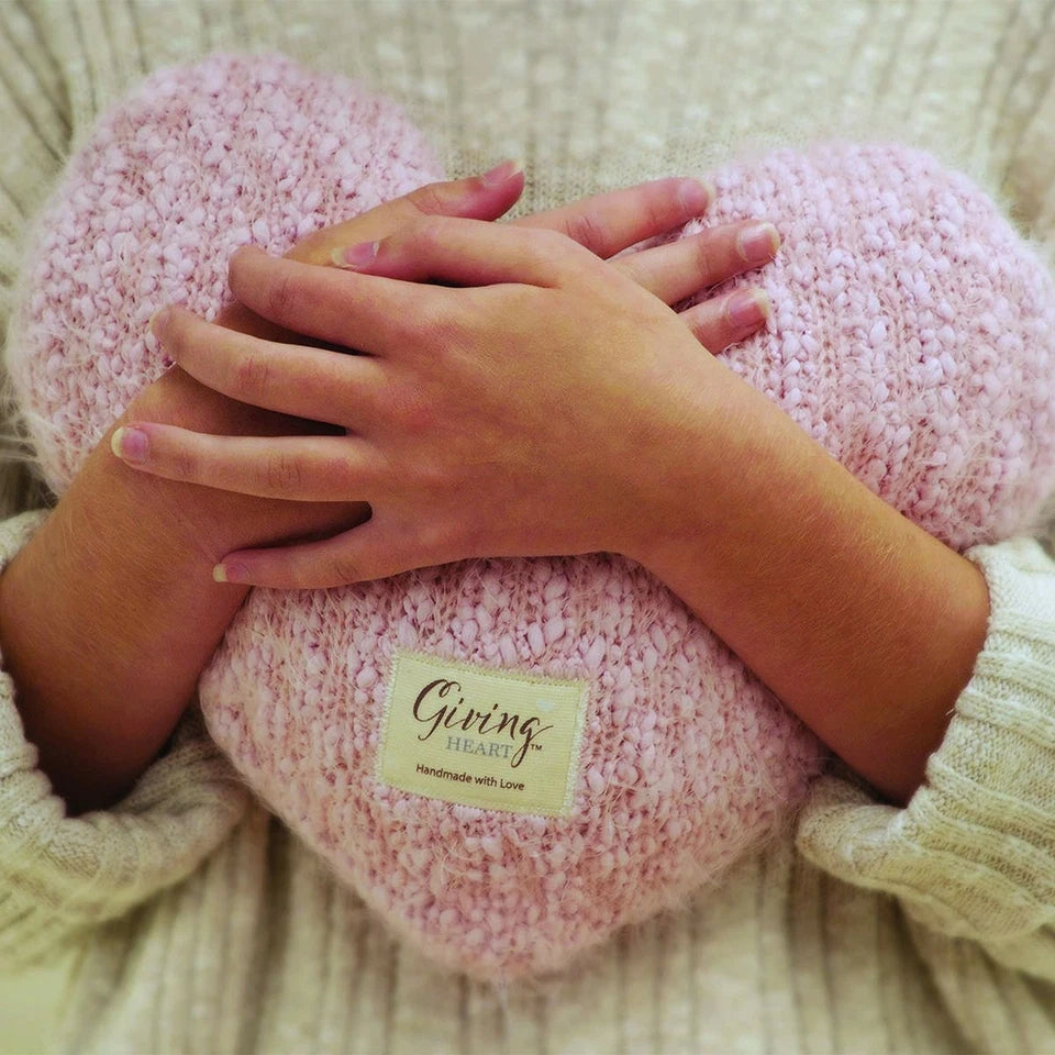 Demdaco weighted pink giving heart being held like a hug
