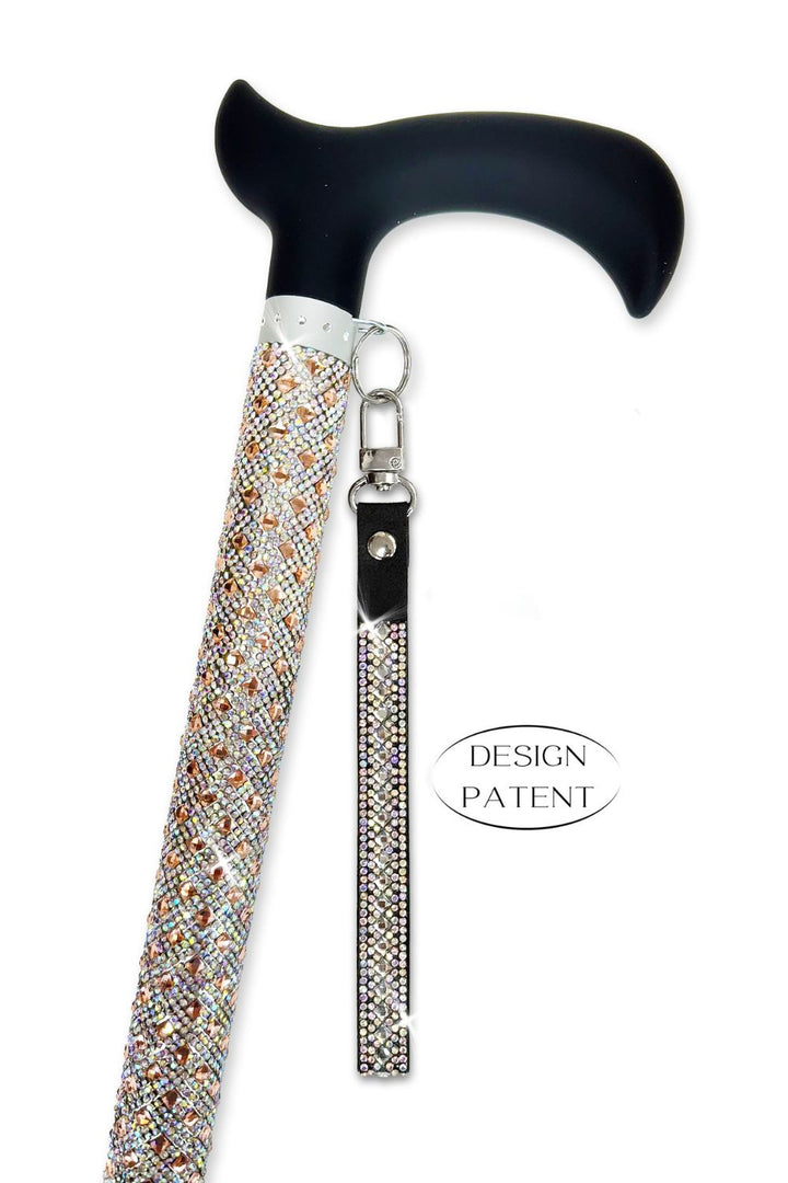 A Jacqueline Kent walking cane with a black curved handle, a rhinestone-embellished shaft, and a matching rhinestone wrist strap with rose gold finish