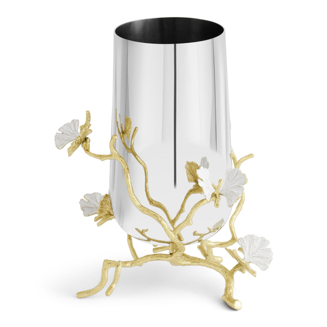 Angled view of a Michael Aram Butterfly Ginkgo medium vase showing sculpted gold ginkgo branches wrapping around the reflective silver-tone body, with dimensional white butterfly-like leaves extending outward and forming the footed base.