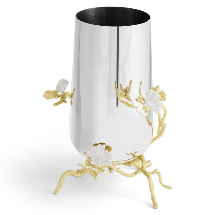 Side view of a Michael Aram Butterfly Ginkgo medium vase showing the curved reflective silver-tone body and raised gold ginkgo branches with white butterfly-like leaves projecting beyond the surface.