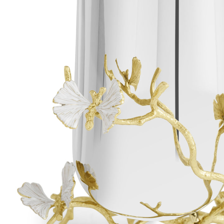 Close-up of a Michael Aram Butterfly Ginkgo Gold Vase showing the sculpted texture of the gold ginkgo branches and dimensional white enamel butterfly-like leaves against the reflective silver-tone metal body.