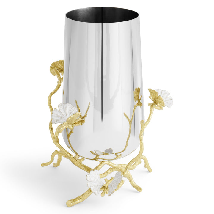 A Michael Aram modern cylindrical metal medium vase, 9.75 inches high, with a reflective silver-tone body, decorated with sculpted gold ginkgo branches and white ginkgo leaf accents that resemble butterflies.