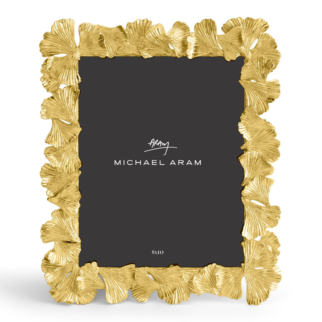 Michael Aram 8x10" gold picture frame with a textured, ginkgo leaf scalloped border, shown with a black insert displaying the Michael Aram logo, displayed vertically