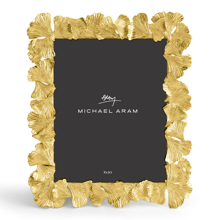 Michael Aram 8x10" gold picture frame with a textured, ginkgo leaf scalloped border, shown with a black insert displaying the Michael Aram logo, displayed vertically