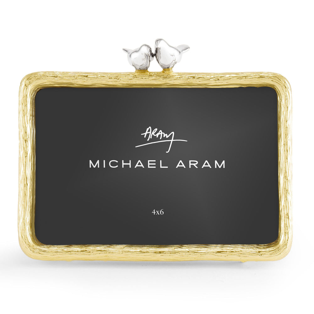 Front view of Michael Aram Lovebirds 4x6 picture frame with textured goldtone frame and two sculpted silver-tone lovebirds perched together at the top