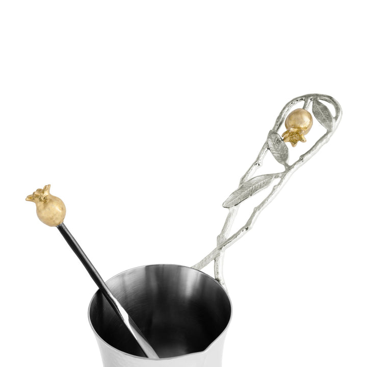 Close-up of Michael Aram Pomegranate coffee pot showing the open vessel rim and spout, sculptural silver-tone branch handle with leaves and gold-tone pomegranate accent 