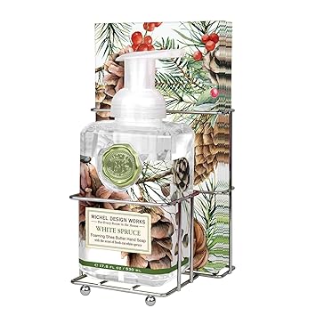 Decorative soap dispenser with Christmas-themed packaging featuring pine cones and berries.Michel Design Works Scented Foaming Hand Soap and Napkin Caddy Set - White Spruce