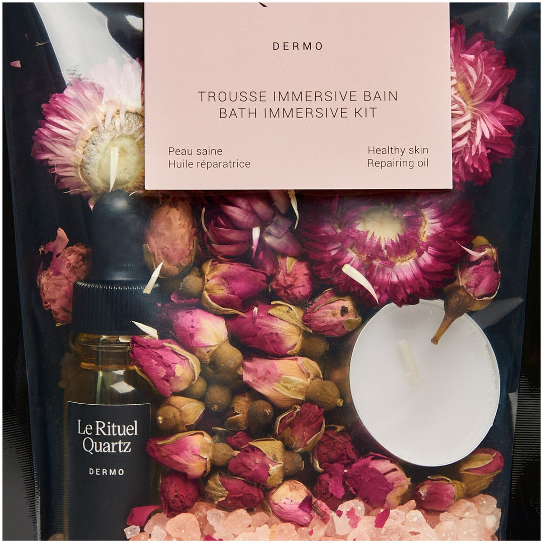 SELV Rituel Quartz Immersive Bath Ritual Kit close-up with rose buds, flowers, pink bath salts, botanical oil and floating candle