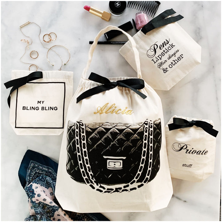 Bag-all Personalized drawstring bag with quilted design, surrounded by jewelry and makeup items on a marble surface.