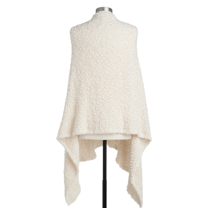 Back of an off-white sherpa fleece shawl vest with an asymmetrical draped hem, displayed on a  mannequin