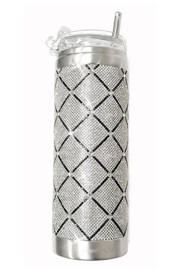 A Jacqueline Kent fancy insulated travel tumbler covered in  silver rhinestones with diamond pattern created by a black  lattice pattern, a stainless steel straw, and a clear plastic lid..
