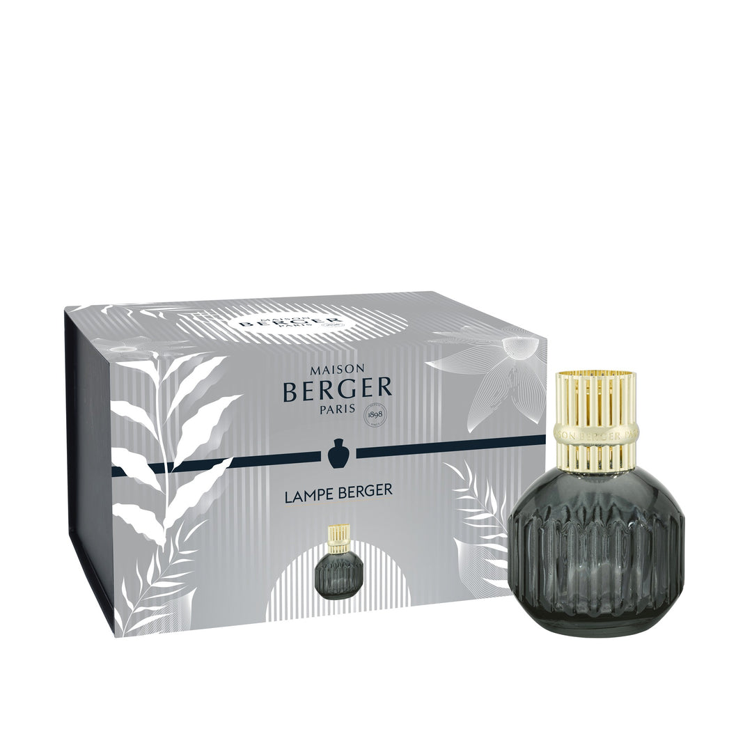 Lampe Berger Cannelo Grey home fragrance lamp in smoke-grey fluted glass with a gold-coloured slotted diffuser top, beside its matching botanical-patterned gift box