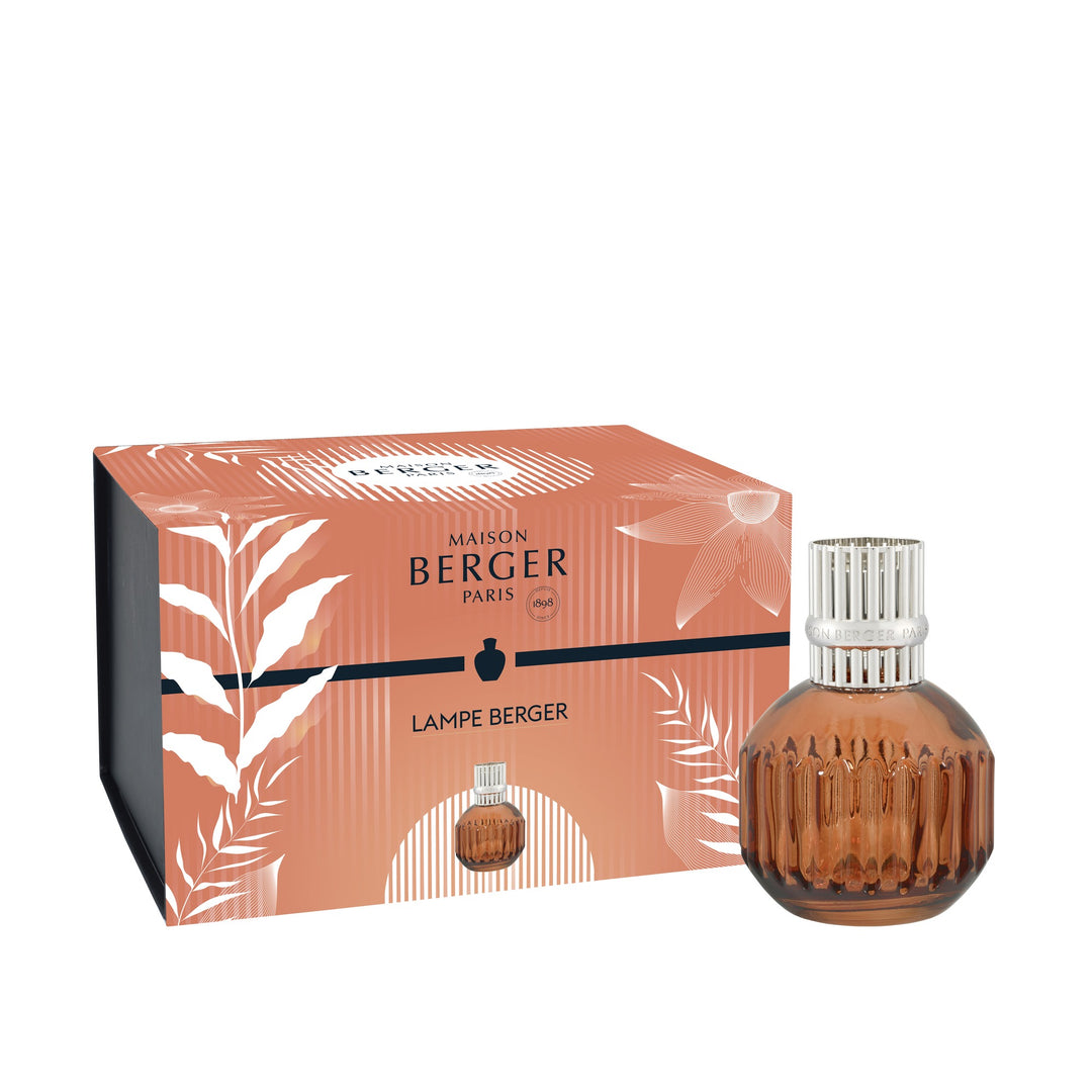 Maison Berger Paris Lampe Berger perfume bottle with a ribbed amber-brown glass body and silver cap, shown next to its orange and white patterned packaging box on a white background.