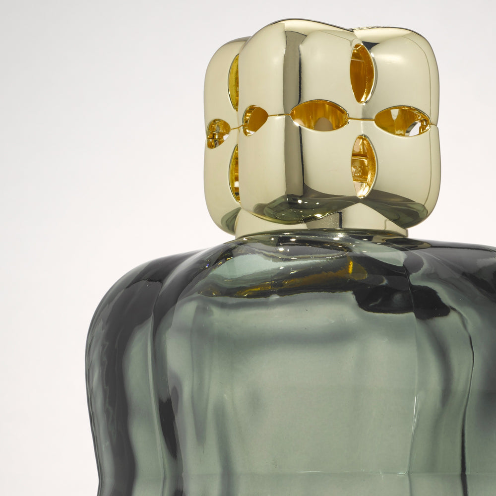 Lampe Berger Cosy Green home fragrance lamp viewed from above, showing the unique gold-coloured diffuser cap and rounded green glass shoulders.
