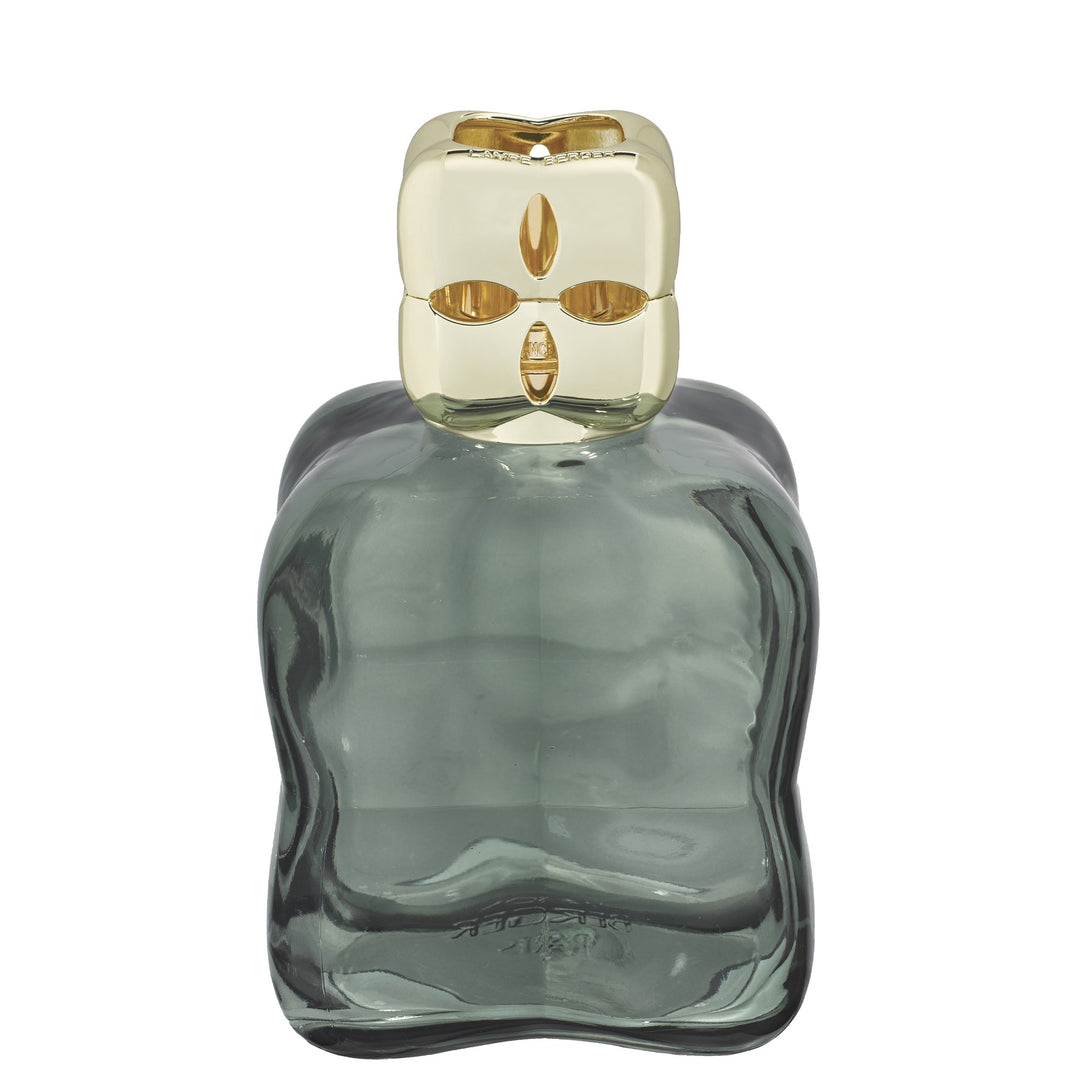 Lampe Berger Cosy Green home fragrance lamp in sculpted green glass with a gold-coloured diffuser cap and oval cut-outs.
