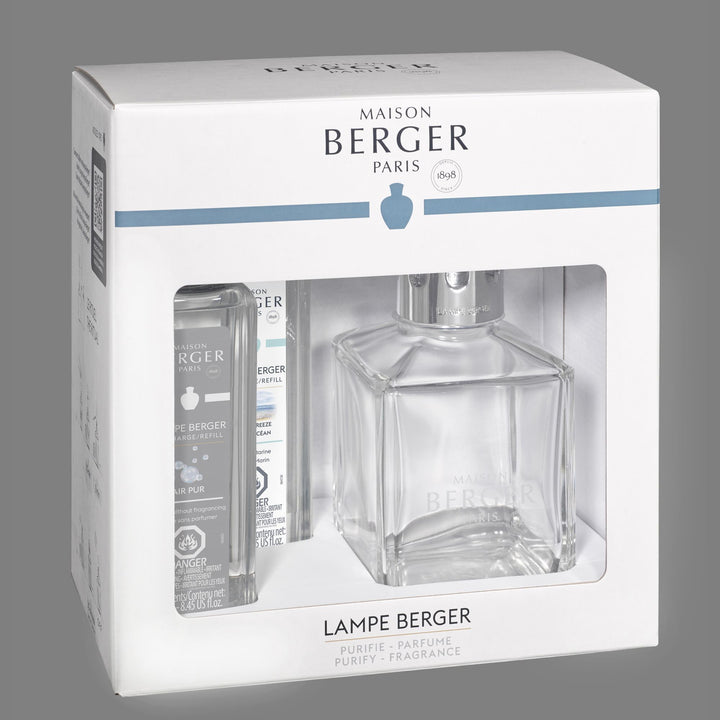 Angled view of the white Maison Berger Essential Square starter-set window box, showing the clear square lamp and two 250 ml refills: Ocean Breeze and Air Pur So Neutral.
