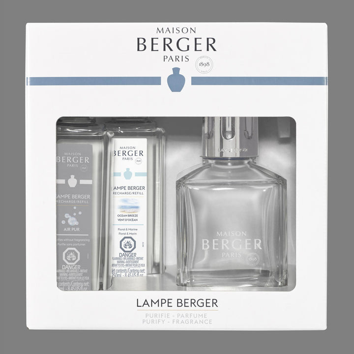 Lampe Berger Essential Square clear glass lamp with polished silver slotted diffuser cap, displayed beside 250 ml Ocean Breeze and 250 ml Air Pur So Neutral refill bottles.
