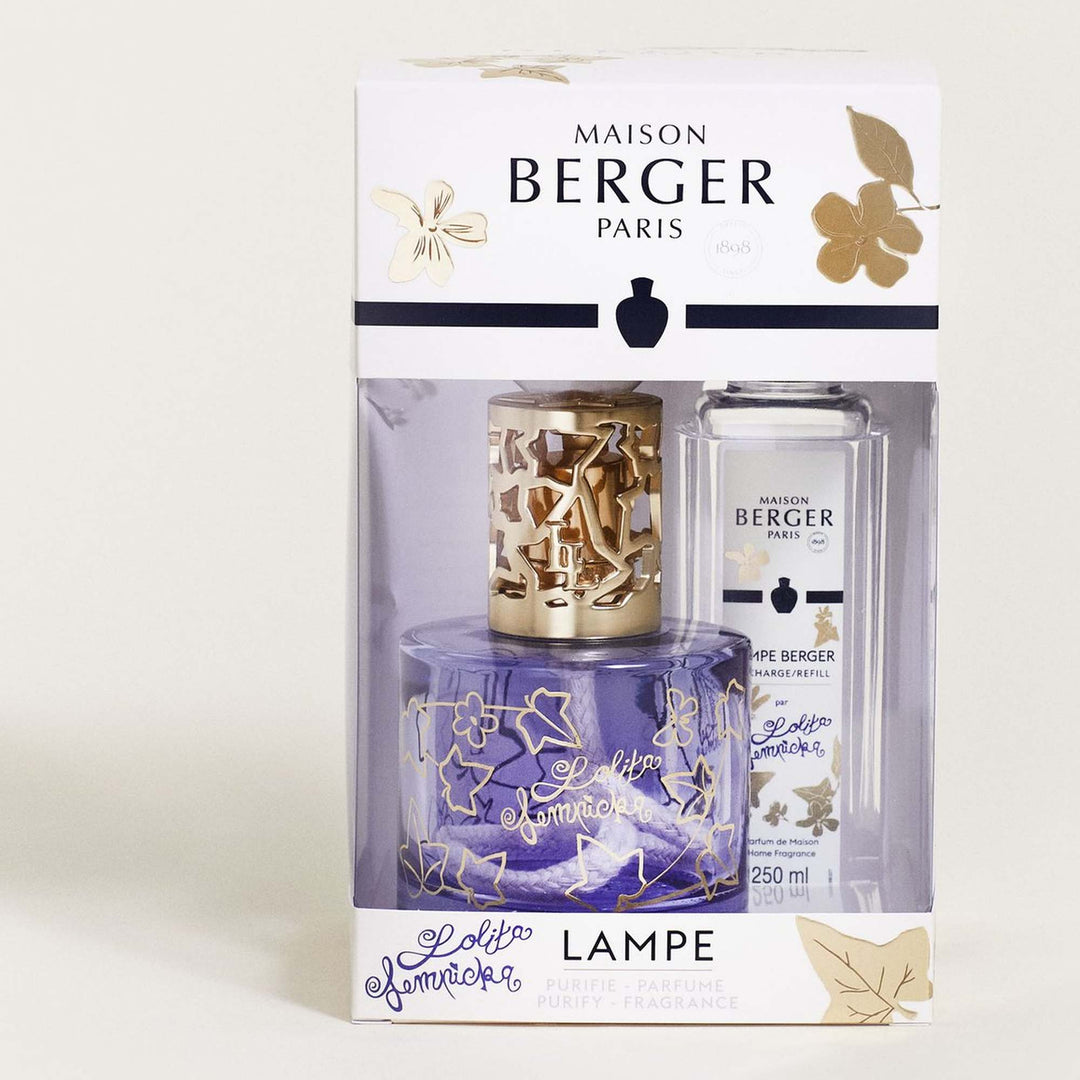 White Maison Berger Lolita Lempicka presentation box decorated with gold ivy leaves, with a clear window displaying the violet-blue lamp and matching 250 ml fragrance refill.
