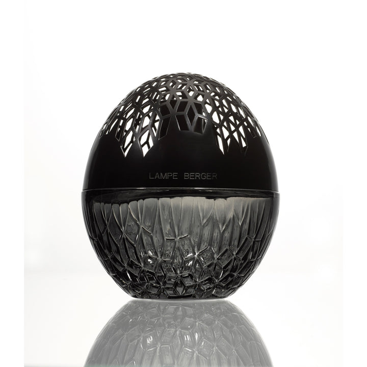 Lampe Berger Luka Black home fragrance lamp OVAL in dark patterned glass with a black domed top with geometric cut-outs, reflected on the surface below.
