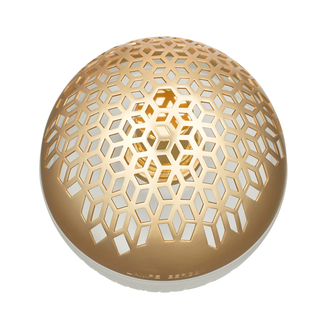 Lampe Berger Luka home fragrance lamp - A spherical shape diffuser close up with a warm gold-toned metallic honeycomb cutout pattern, 