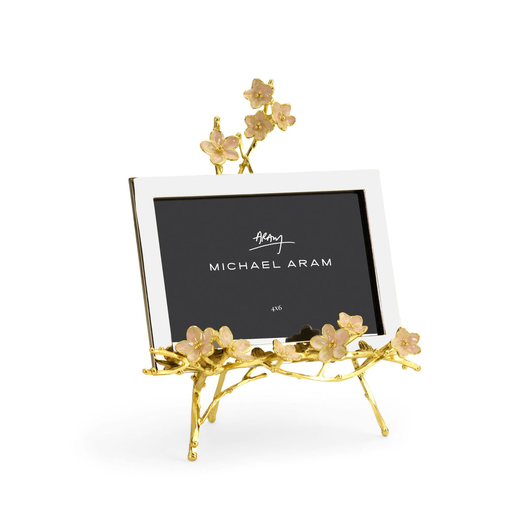 Michael Aram Cherry Blossom Easel Photo Frame 4x6 with pink enamel cherry blossoms and goldtone details. Left angle image