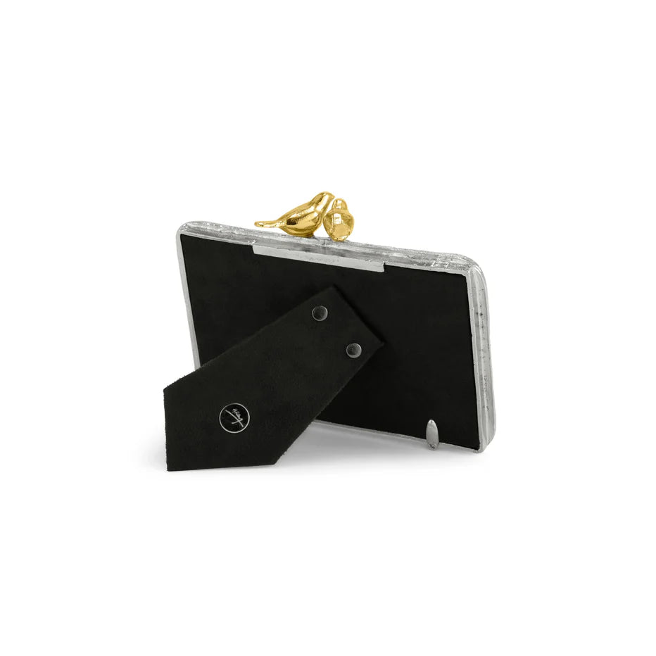 Back angled view of Michael Aram Lovebirds 4x6 picture frame showing the textured silver-tone frame, sculpted gold-tone lovebirds and black easel stand