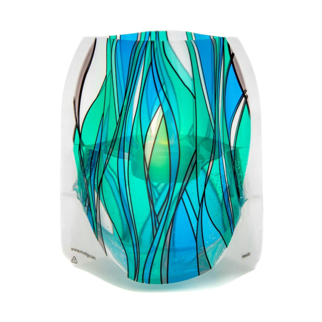 Modgy Heedo LED luminary featuring a stained-glass-like geometric design in vibrant blue, aqua and green with floating LED water activated candle inside.