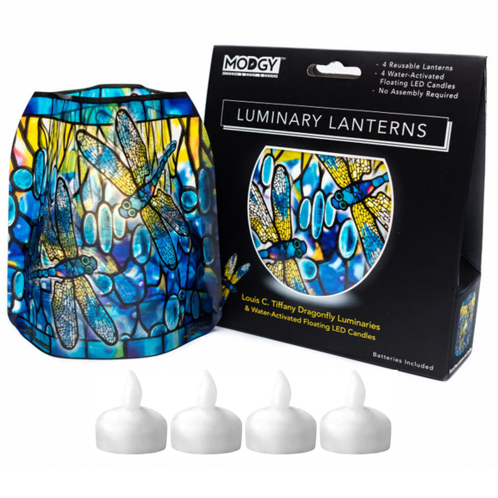 A stained-glass-style Tiffany dragonfly Mody luminary lantern in blue, yellow, and green is shown next to its black Modgy brand gift box, with four small white battery-operated water activated flameless candles.