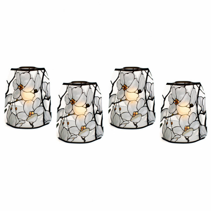 Set of four stained-glass-style reusable Modgy LED luminary lanterns featuring the Tiffany Magnolia Window design inspired by Louis C. Tiffany, illuminated with water-activated floating LED candles.