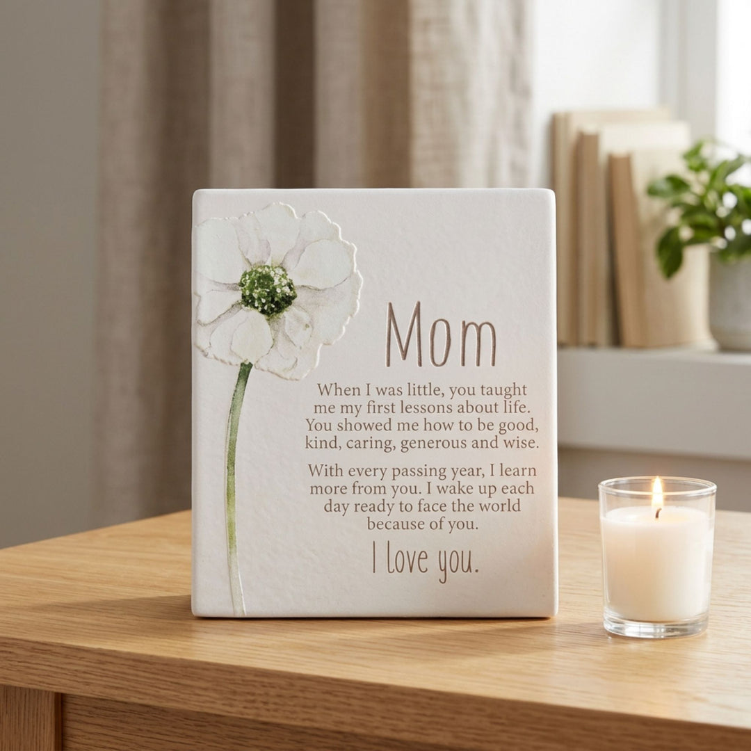 Mom sentiment plaque displayed on a tabletop beside a candle